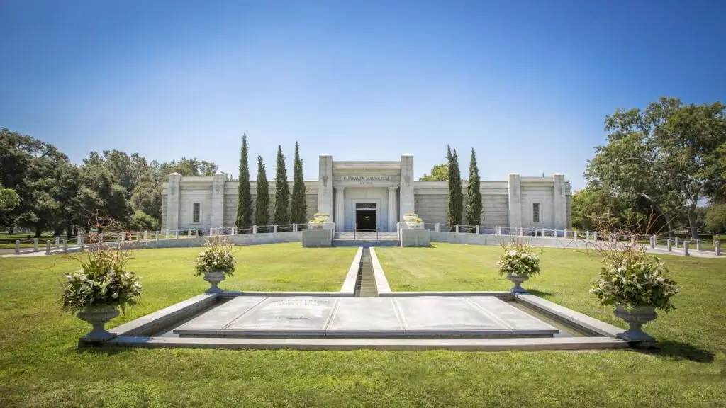 A scenic view of Fairhaven Memorial Park featuring its iconic mausoleum, lush green grounds, and tranquil surroundings.