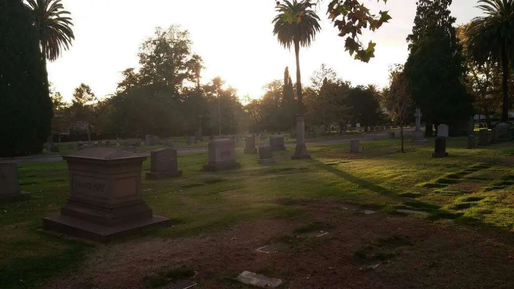 Serene sunset view at Mountain View Cemetery in Altadena, CA, showcasing well-maintained grounds and historic monuments.