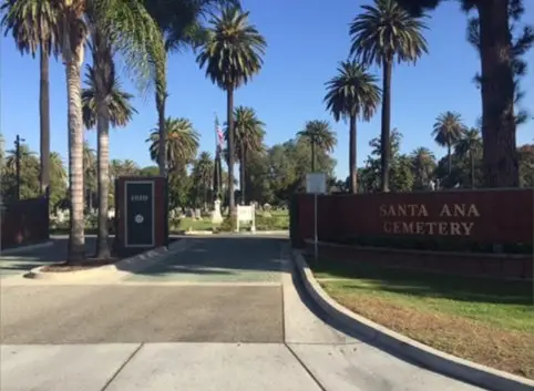 Entrance to Santa Ana Cemetery with palm trees lining the pathway