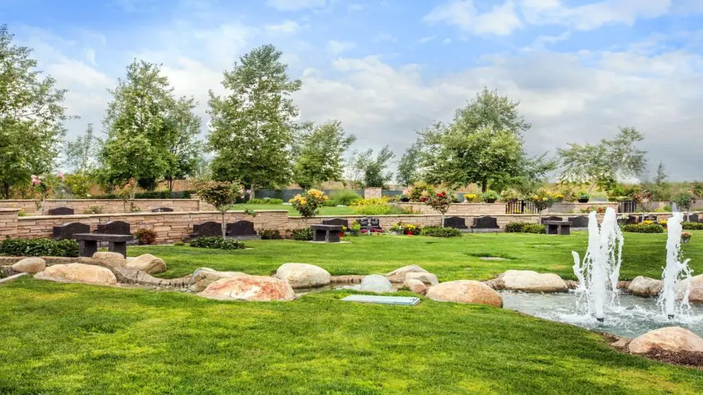 A tranquil memorial fountain surrounded by greenery at Westminster Memorial Park, offering a peaceful and serene environment.