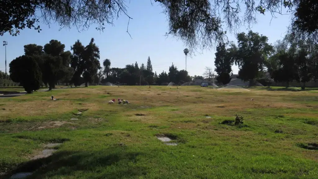 A peaceful view of Paradise Memorial Park in Santa Fe Springs, CA, featuring lush greenery and well-maintained grounds, providing a serene resting place for loved ones.