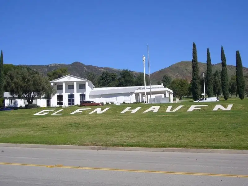 Entrance of Glen Haven Memorial Park with lush greenery and serene landscape.
