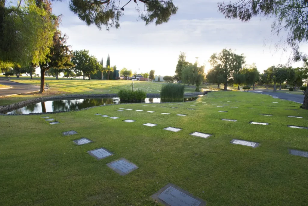 Serene landscape at Greenlawn Memorial Park Northeast featuring well-maintained flat bronze plaques.