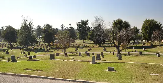 A scenic view of Long Beach Municipal Cemetery in California, featuring well-maintained green spaces and historic graves.