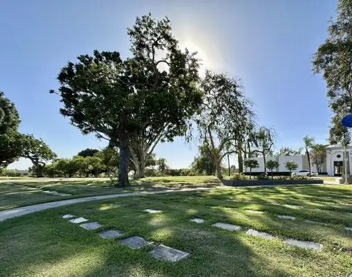 Serene landscape with lush green grass and trees at Memory Garden Memorial Park & Mortuary in Brea, CA