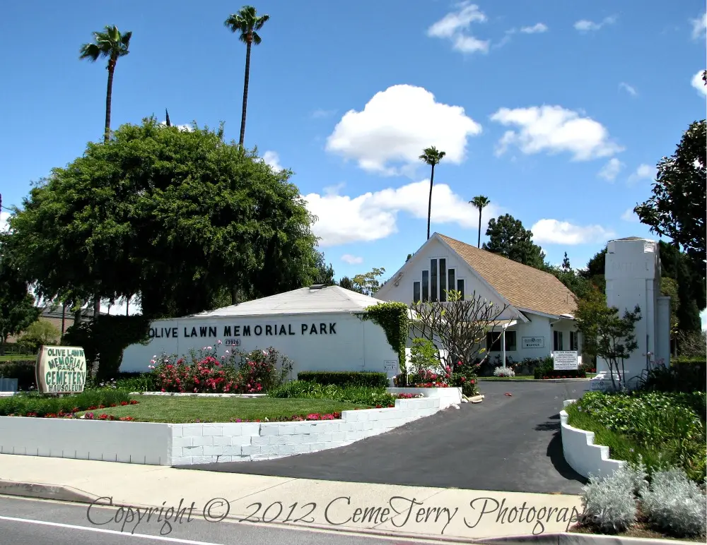 Entrance of Olive Lawn Memorial Park Cemetery in Chatsworth, CA, surrounded by lush greenery and a peaceful setting.