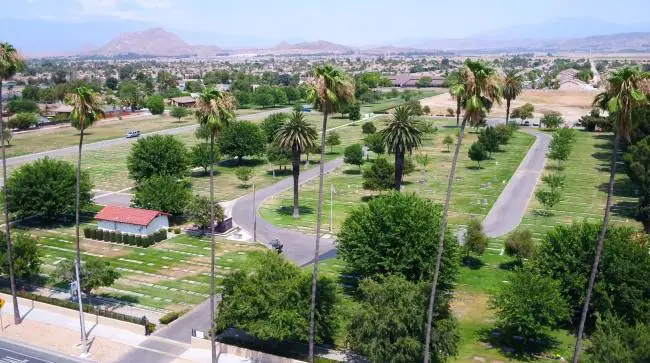 Aerial view of Perris Valley Cemetery District, showcasing green landscapes, tree-lined pathways, and memorial sites.