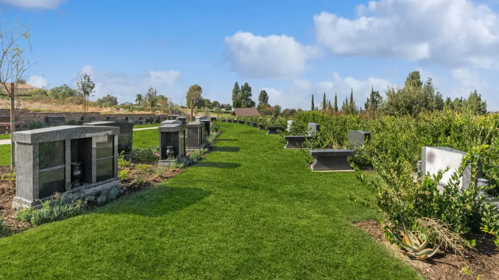 Serene memorial gardens and mausoleums at Pierce Brothers Crestlawn Memorial Park & Mortuary, featuring beautifully designed granite niches and burial sites.