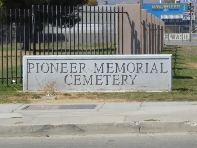 Concrete entrance sign with engraved letters spelling "Pioneer Memorial Cemetery," located in San Bernardino, California.