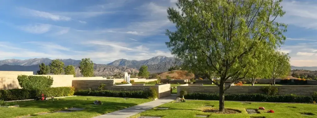 View of Forest Lawn Covina Hills Cemetery with mountain background and peaceful greenery