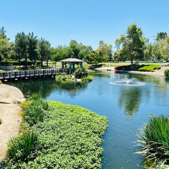 Peaceful landscape at MiraLago Funerals & Cremations in Riverside, CA, featuring a lake and garden bridge