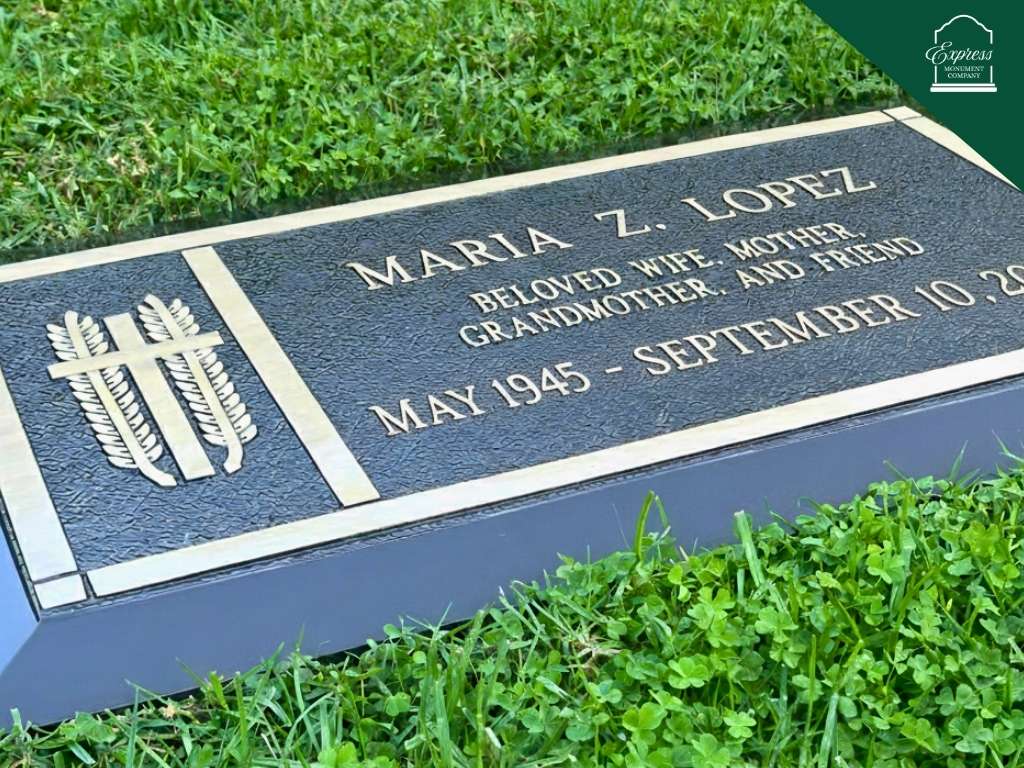 flat bronze headstone installed on grass cemetery setting